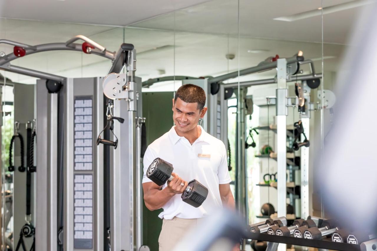 Outrigger Surin Beach Resort - Sha Extra Plus 외부 사진 A man lifting a dumbbell