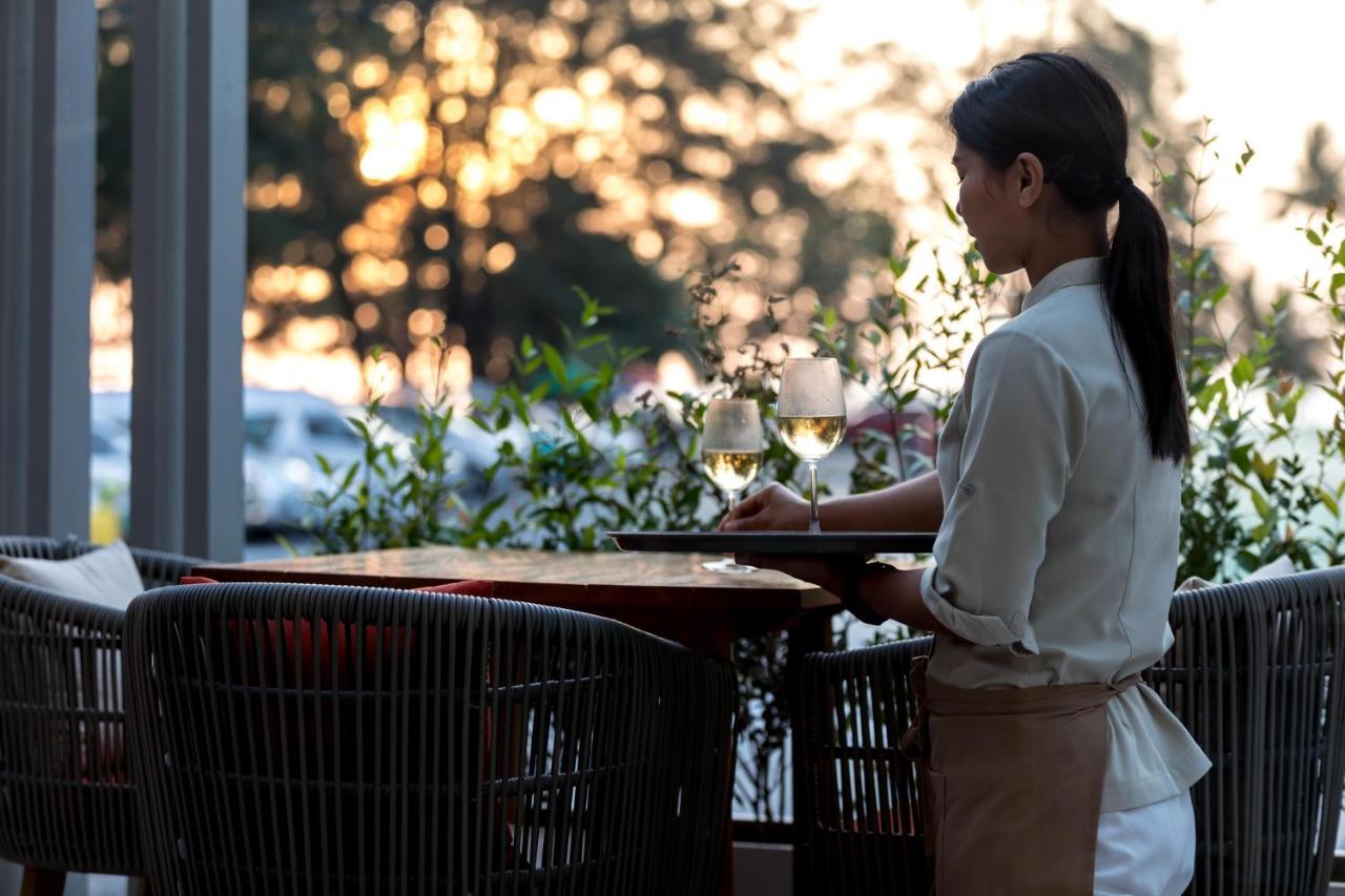 Outrigger Surin Beach Resort - Sha Extra Plus 외부 사진 A waitress clearing a table