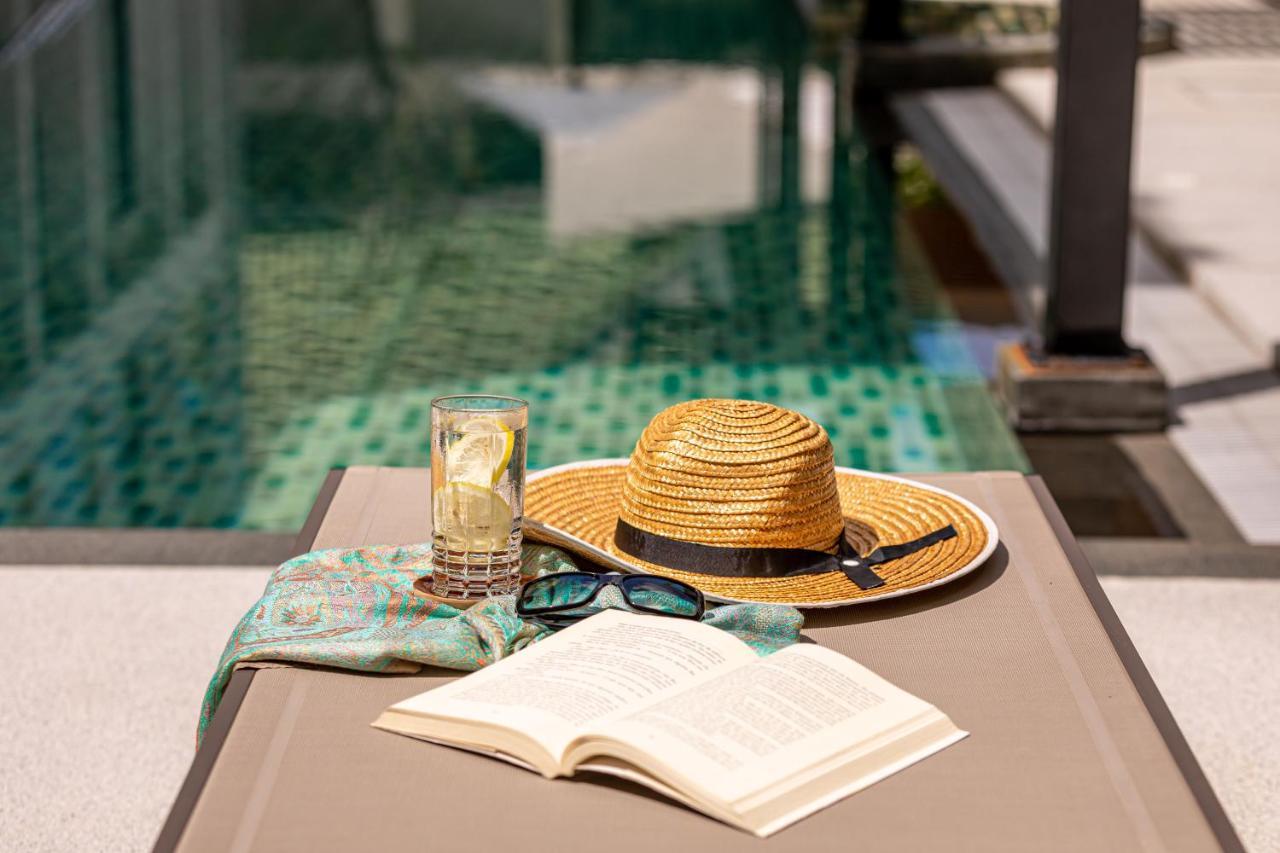 Outrigger Surin Beach Resort - Sha Extra Plus 외부 사진 A poolside table